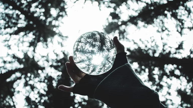 Main symbolizing the release of a burden through a transparent glass sphere.